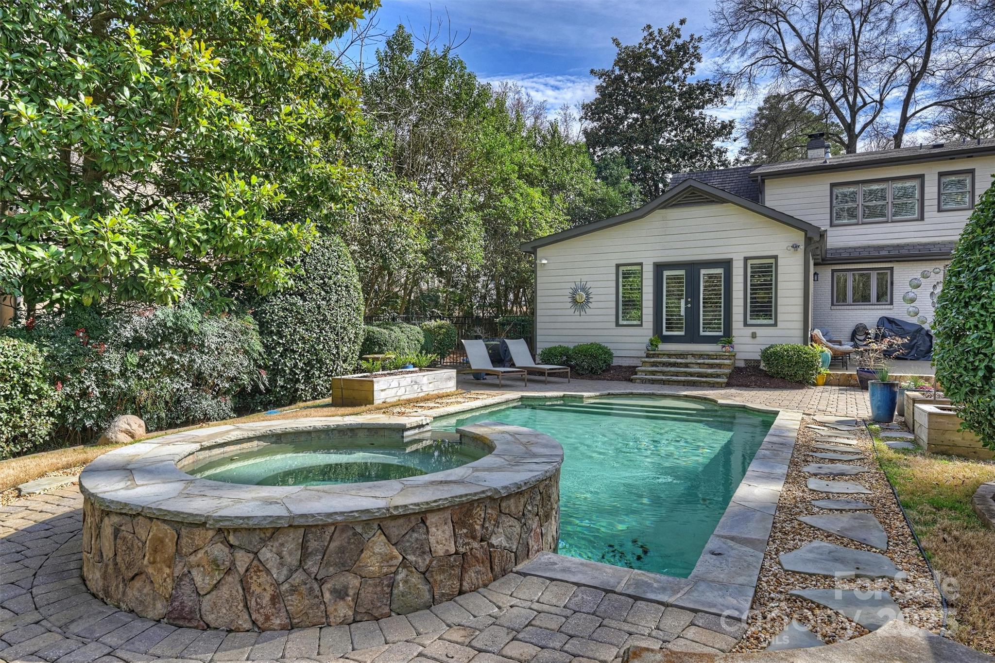 830 Jefferson Drive Charlotte, NC 28270 - Photo 31 of 38 a view of a house with backyard sitting area and swimming pool