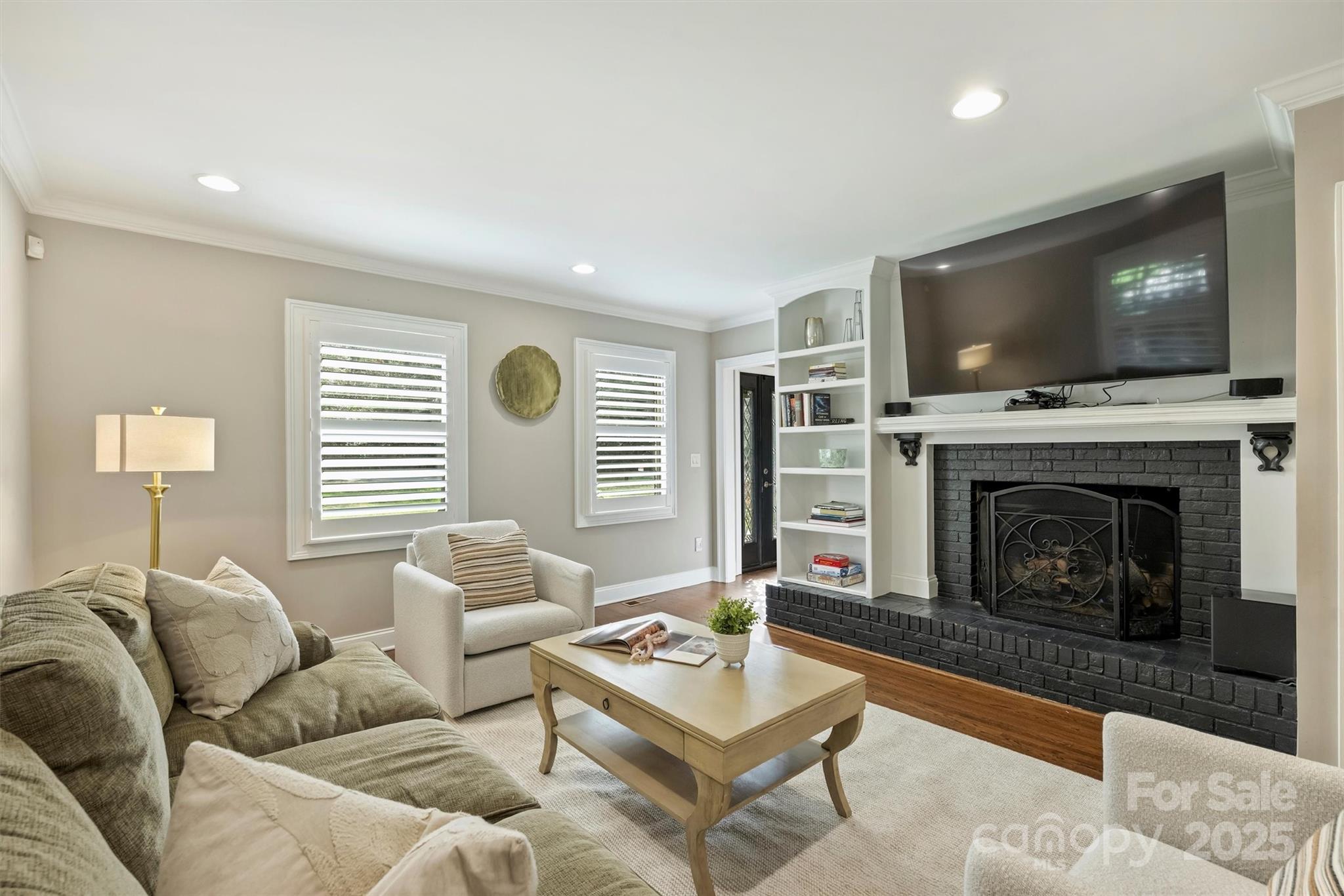 830 Jefferson Drive Charlotte, NC 28270 - Photo 5 of 38 a living room with furniture a flat screen tv and a fireplace