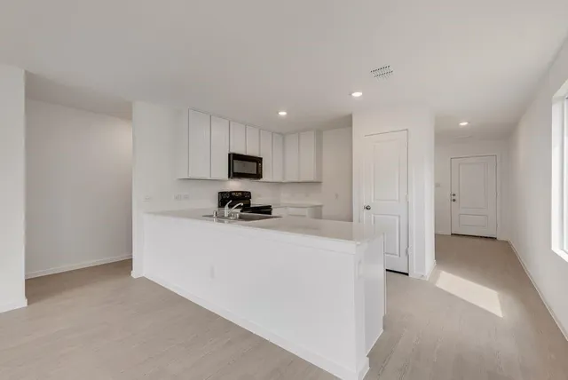 a view of a kitchen with sink dishwasher and a refrigerator