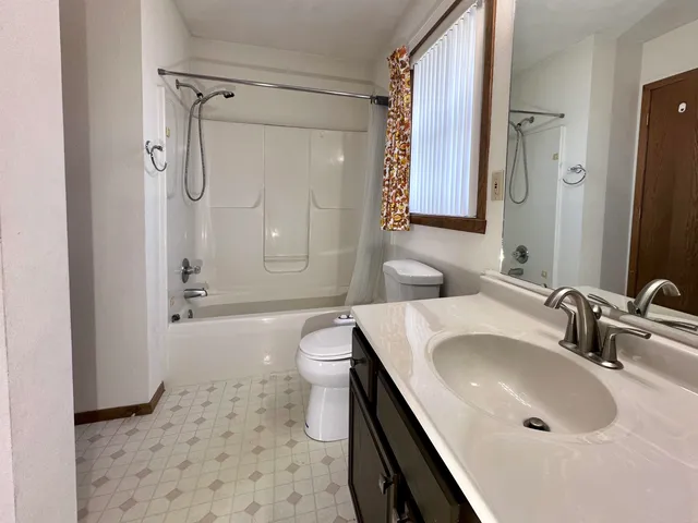 a bathroom with a sink toilet a mirror and shower