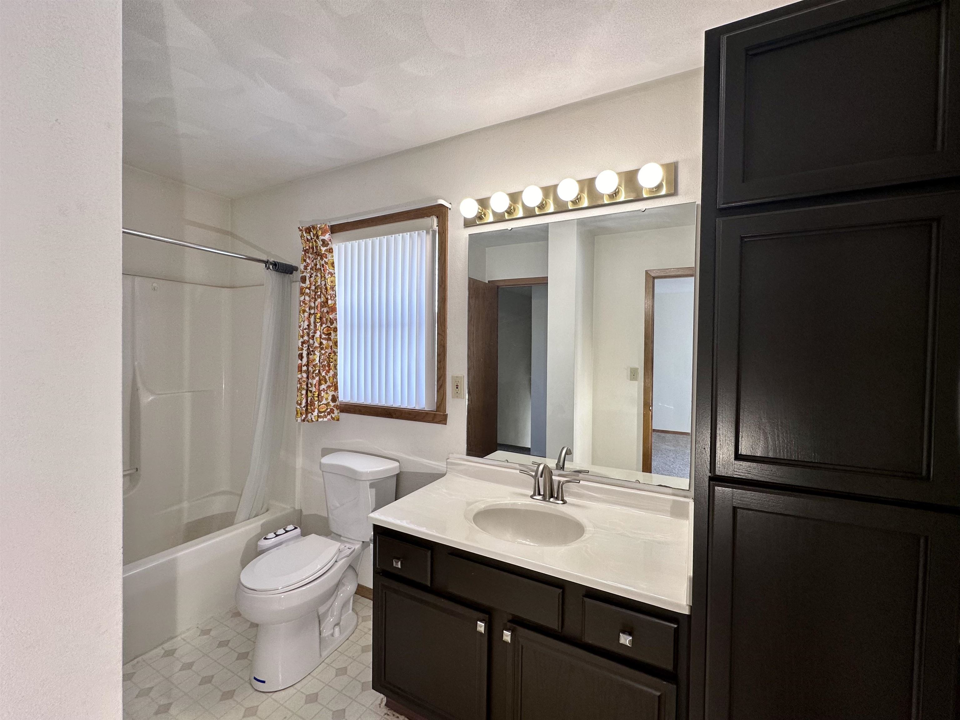 6497 Maeve Lane Rockford, IL 61107 - Photo 12 of 24 a bathroom with a sink toilet a mirror and shower