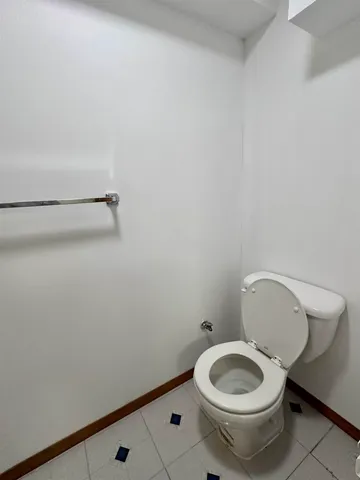 a view of an empty room with stairs and closet