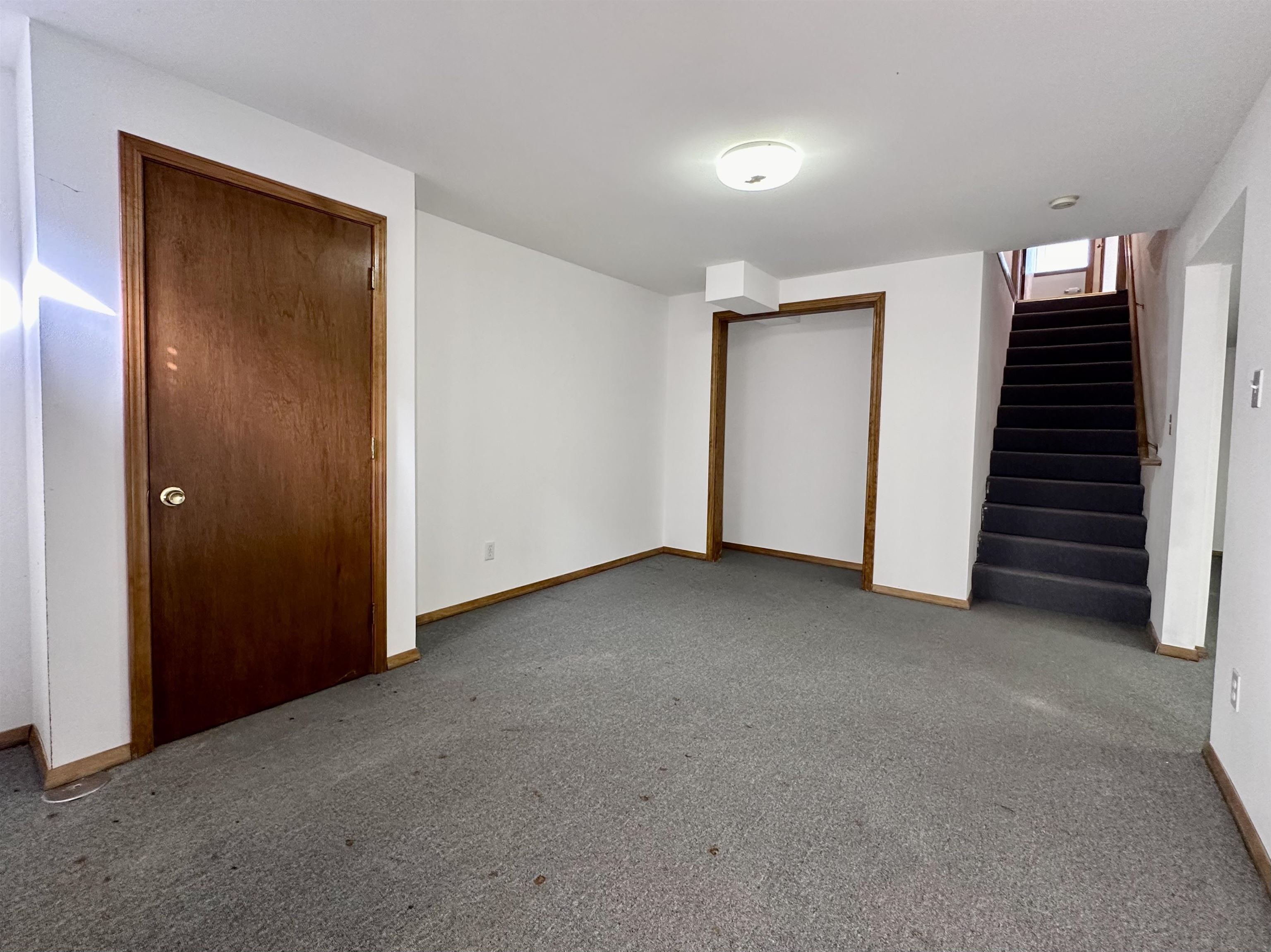 6497 Maeve Lane Rockford, IL 61107 - Photo 18 of 24 a view of an empty room with stairs and closet