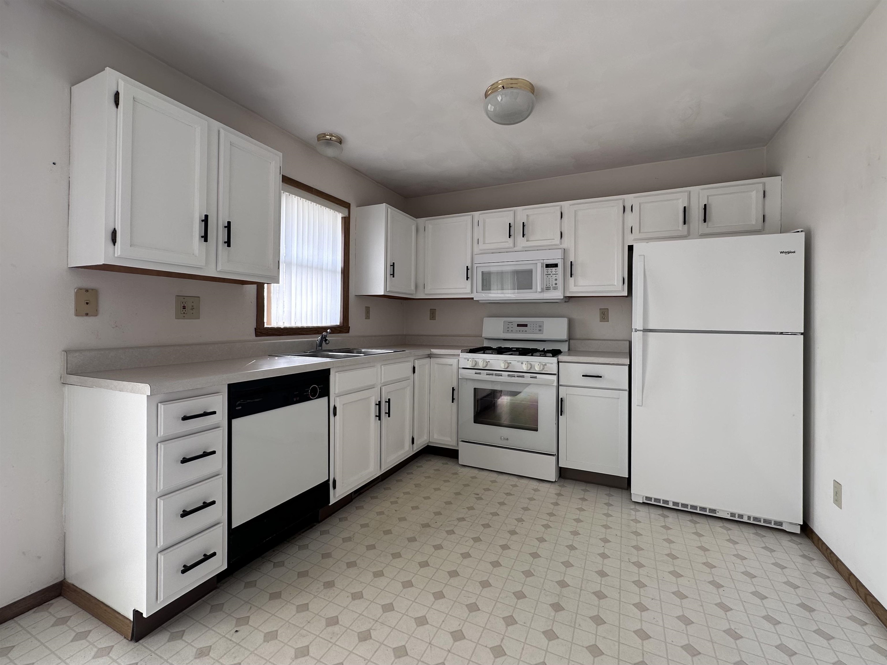 6497 Maeve Lane Rockford, IL 61107 - Photo 3 of 24 a kitchen with cabinets stainless steel appliances and sink