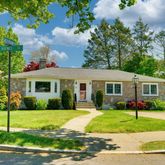 a front view of house with yard and green space