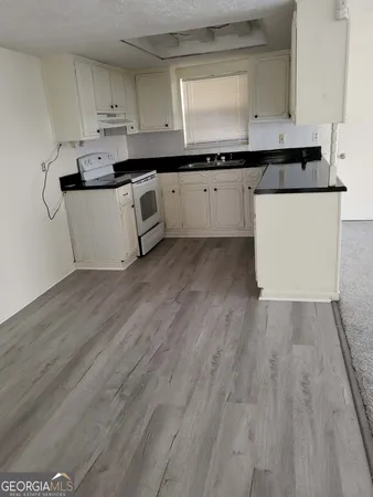 a kitchen with stainless steel appliances granite countertop a sink and cabinets