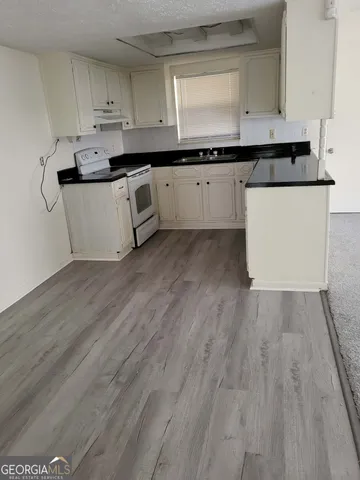 a kitchen with stainless steel appliances granite countertop a sink and cabinets