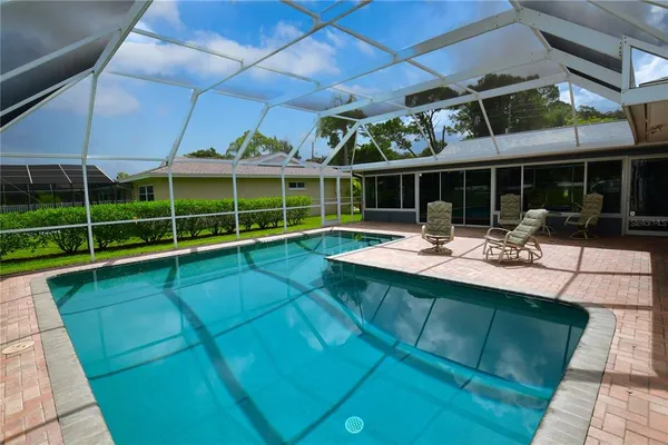 a view of a house with a backyard patio and sitting area