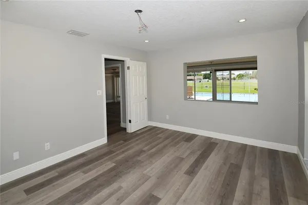 an empty room with windows and closet