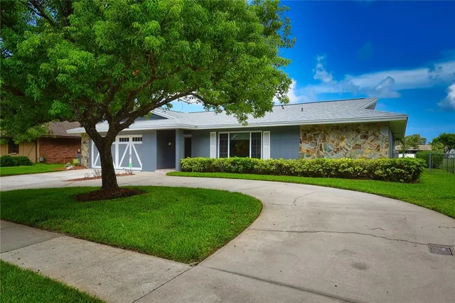 a front view of house with yard and green space