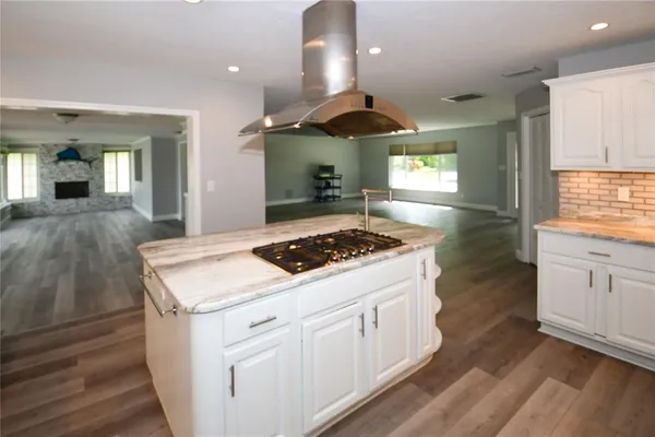 a kitchen with stove a sink and a refrigerator