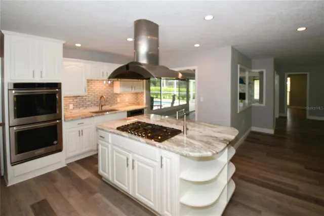 a kitchen with a stove and cabinets