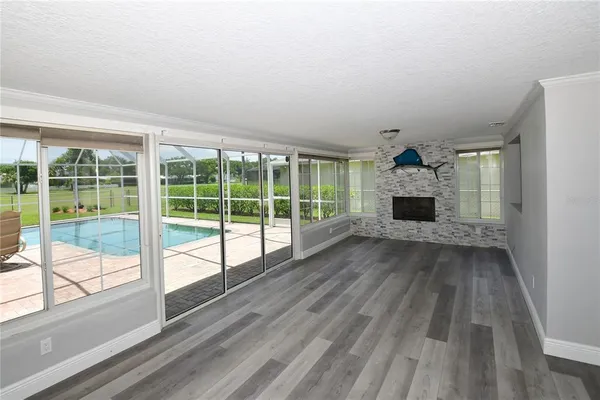 a view of empty room with wooden floor and fireplace