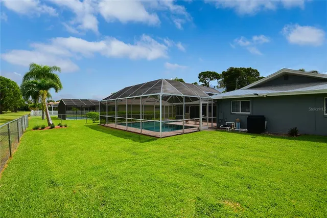 a view of a backyard with a garden and entertaining space