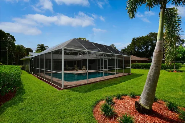 a view of a house with a backyard