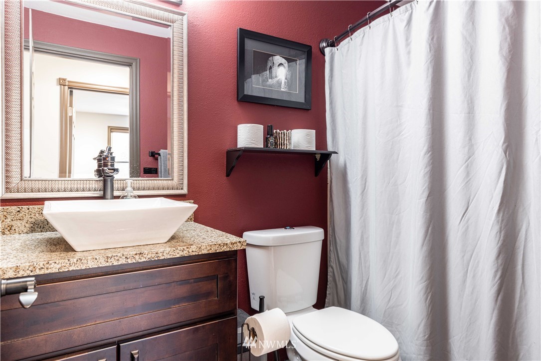 25904 202nd Avenue Southeast Covington, WA 98042 - Photo 15 of 24 a bathroom with a granite countertop toilet sink and mirror