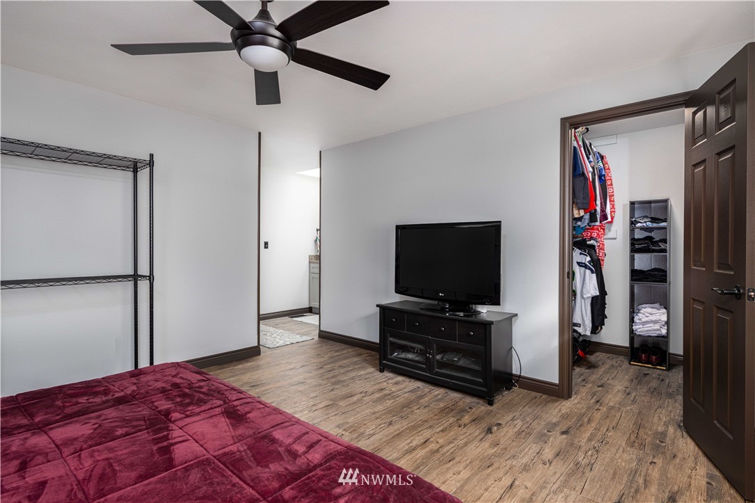 25904 202nd Avenue Southeast Covington, WA 98042 - Photo 18 of 24 a view of a bedroom with a flat tv and a dresser