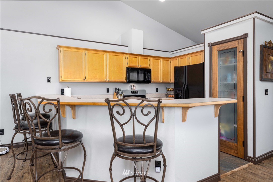 25904 202nd Avenue Southeast Covington, WA 98042 - Photo 7 of 24 a kitchen with a refrigerator and a chair