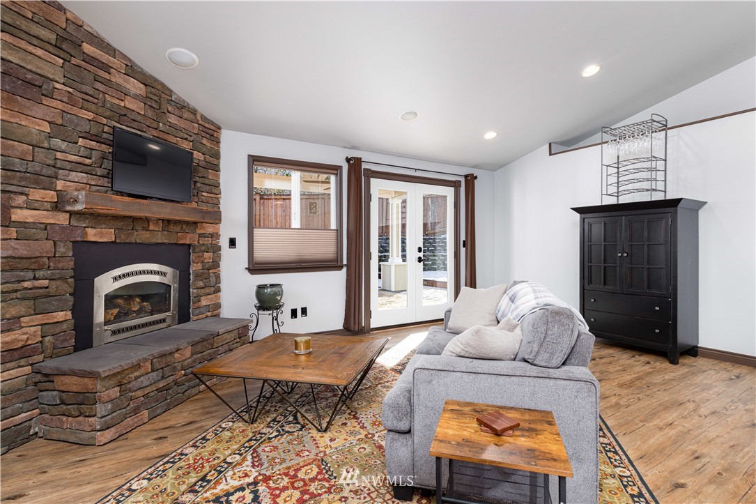 25904 202nd Avenue Southeast Covington, WA 98042 - Photo 10 of 24 a living room with furniture a flat screen tv and a fireplace