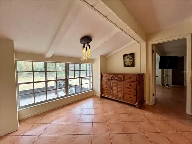 a large space with wooden floor and natural light