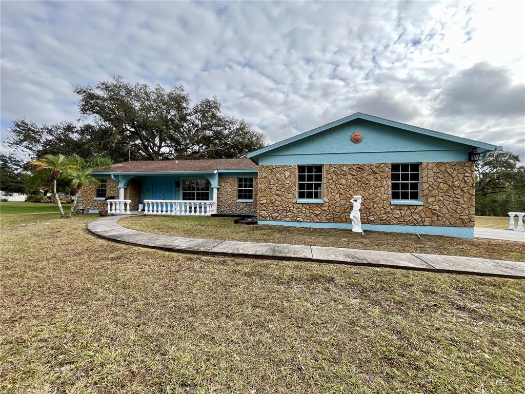 6604 Flicker Court Seffner, FL 33584 - Photo 2 of 32 a front view of a house with garden