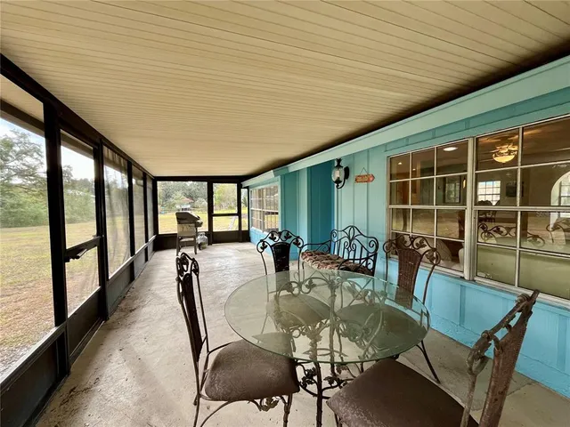 a dining room with furniture window and wooden floor