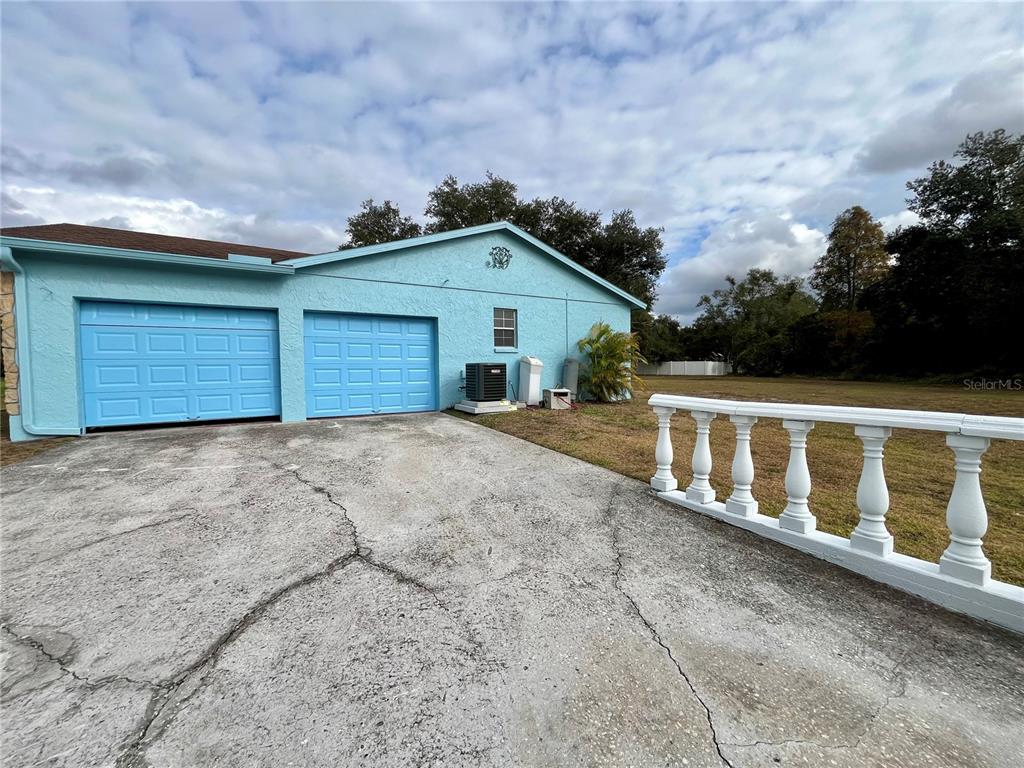 6604 Flicker Court Seffner, FL 33584 - Photo 30 of 32 a front view of a house with a yard and garage