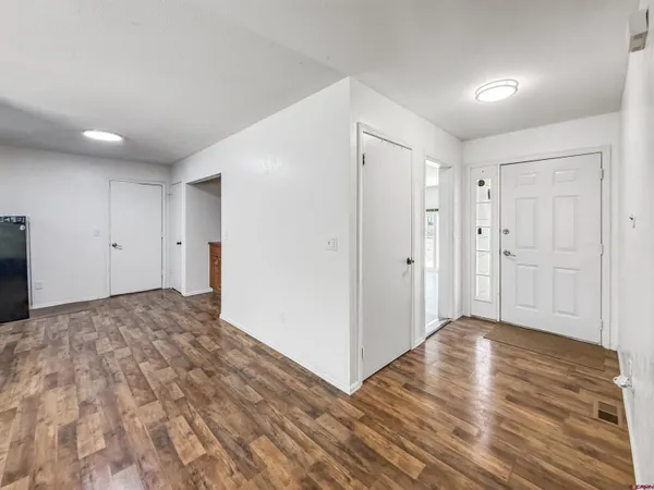 a bedroom with a bed and a ceiling fan