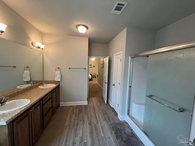 a white toilet sitting next to a white cabinet