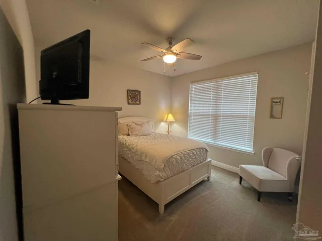 a bedroom with a bed and a tv