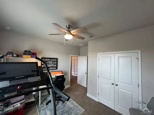 a view of a chairs and backyard with a grill