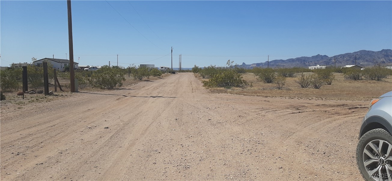 0 South Cowlic Road, Unit 85 Golden Valley, AZ 86413 - Photo 5 of 7 a view of a road with a yard
