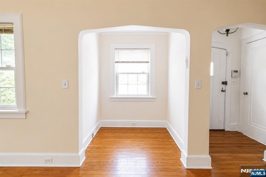 298 Audubon Road Englewood, NJ 07631 - Photo 2 of 19 a view of an empty room with wooden floor and a window