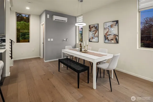 a view of a dining room with furniture and wooden floor