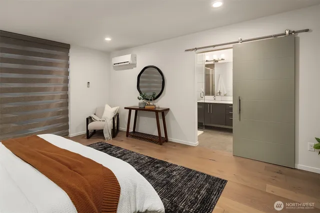 a bedroom with a bed a mirror and a table