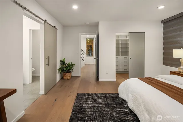 a bedroom with a bed and a potted plant
