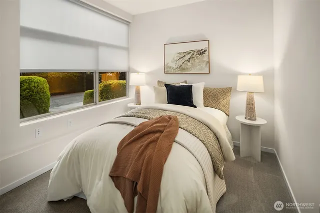 a bed sitting in a bedroom and painting on the wall