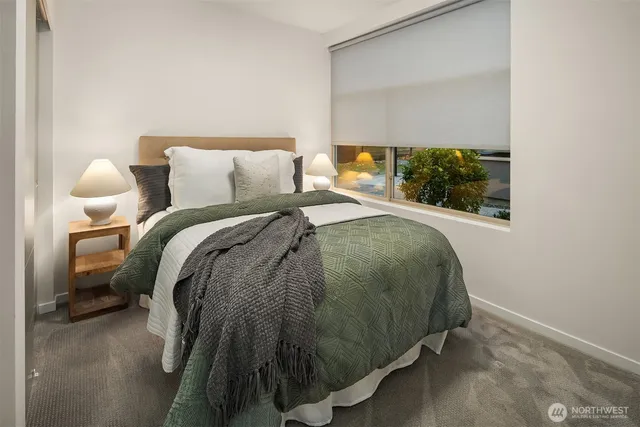 a bed sitting in a bedroom next to a window