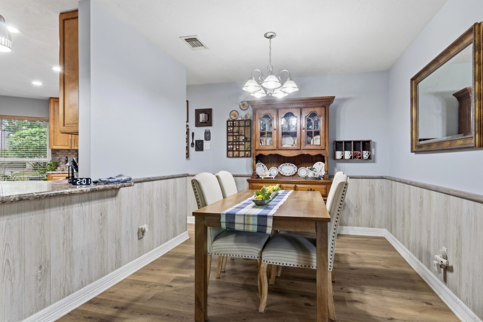 9211 Benwick Street Spring, TX 77379 - Photo 9 of 27 a view of a dining room with furniture window and wooden floor