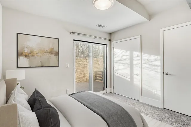 a bedroom with a bed and a large window