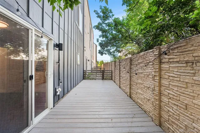 a view of balcony with wooden floor and fence