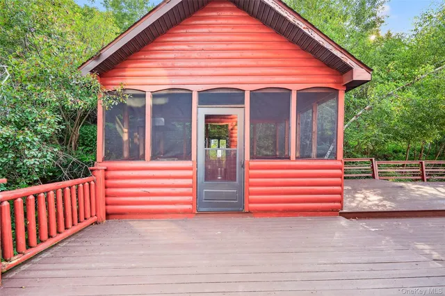 a view of a tennis ground with large trees