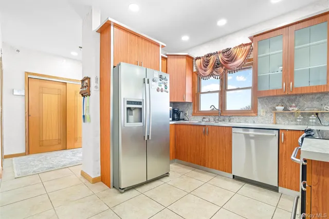 a kitchen with stainless steel appliances granite countertop a stove and cabinets