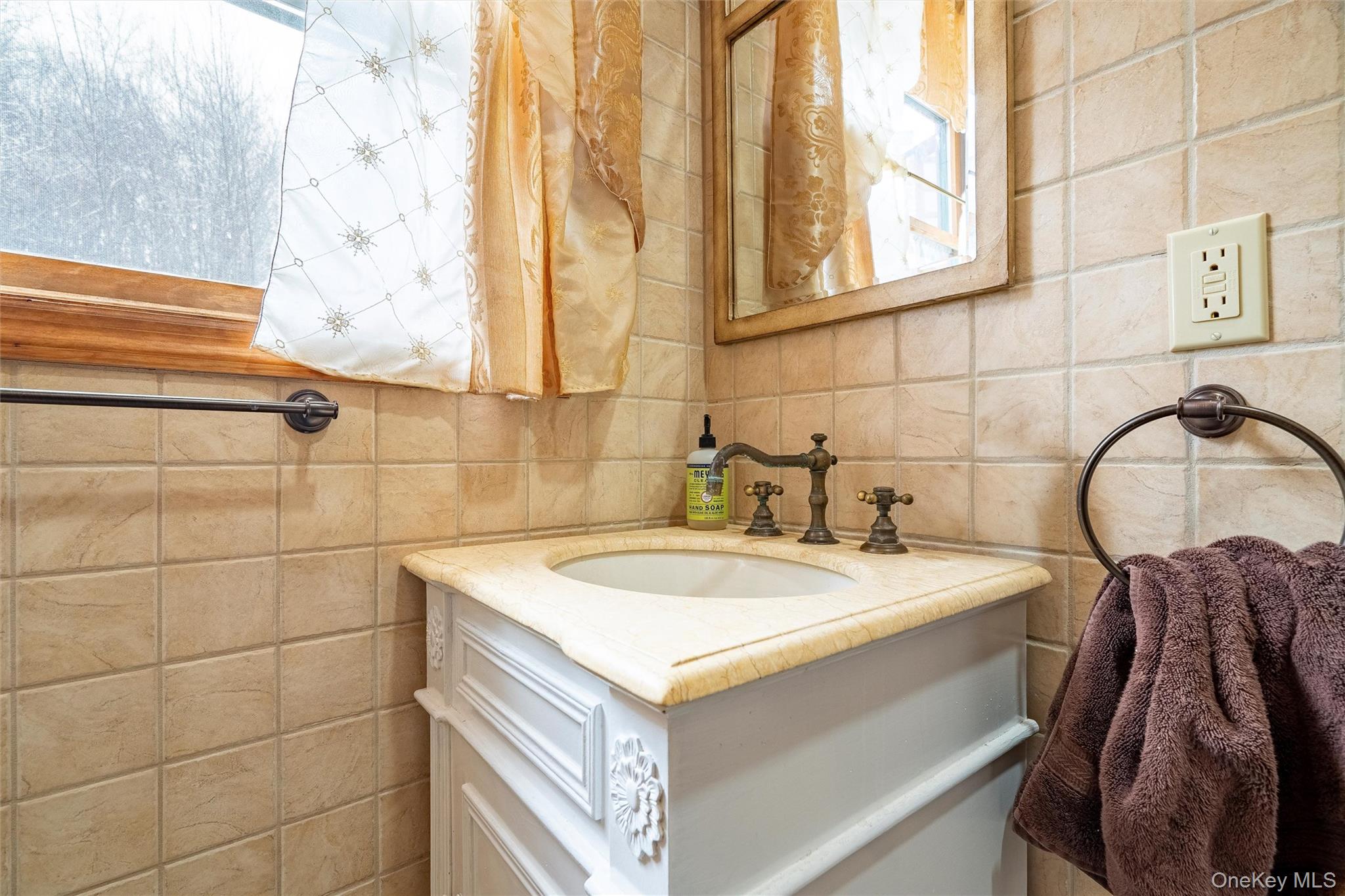 987 Hurd Road Jeffersonville, NY 12748 - Photo 34 of 50 a bathroom with a sink and a mirror