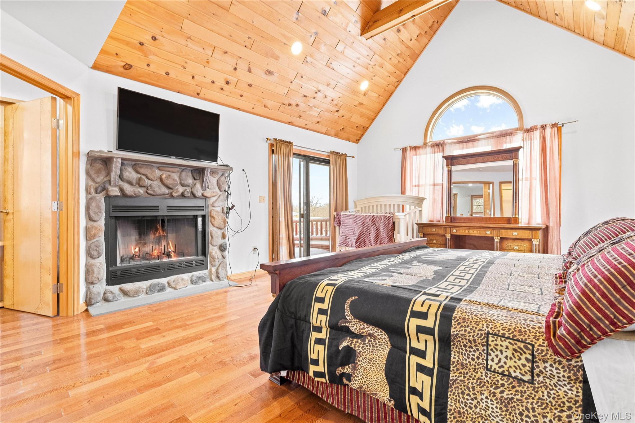 987 Hurd Road Jeffersonville, NY 12748 - Photo 42 of 50 a bedroom with a bed and a fireplace