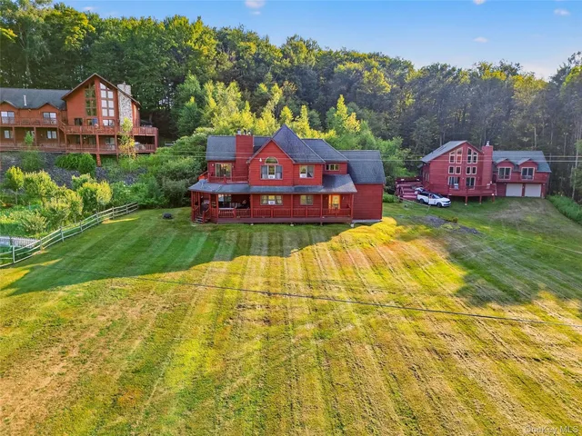 a view of a backyard with plants and large trees