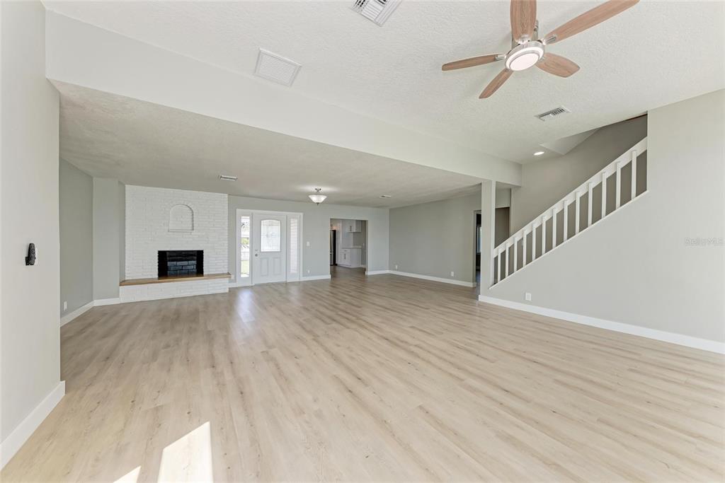893 North Shore Drive Anna Maria, FL 34216 - Photo 12 of 62 a view of an empty room with wooden floor fireplace and a window