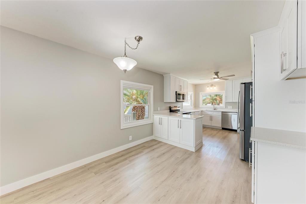 893 North Shore Drive Anna Maria, FL 34216 - Photo 20 of 62 a view of a kitchen with a sink wooden cabinets and window