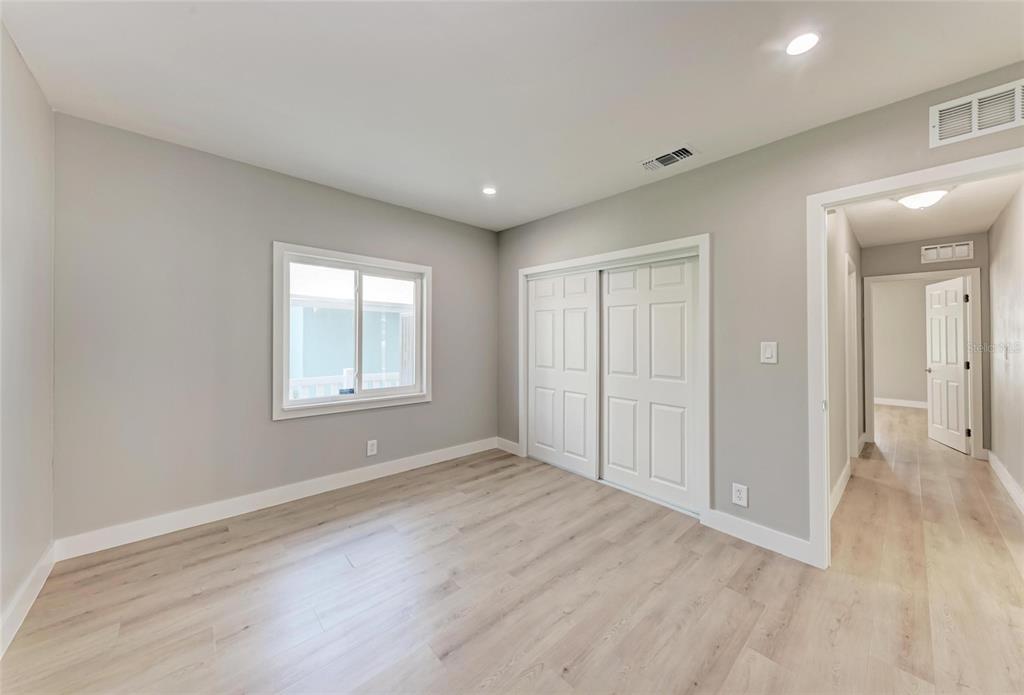 893 North Shore Drive Anna Maria, FL 34216 - Photo 23 of 62 wooden floor in an empty room with a window