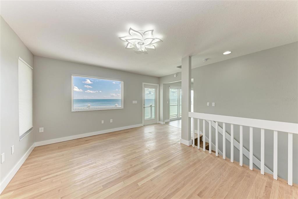 893 North Shore Drive Anna Maria, FL 34216 - Photo 31 of 62 a view of an empty room with wooden floor and a window